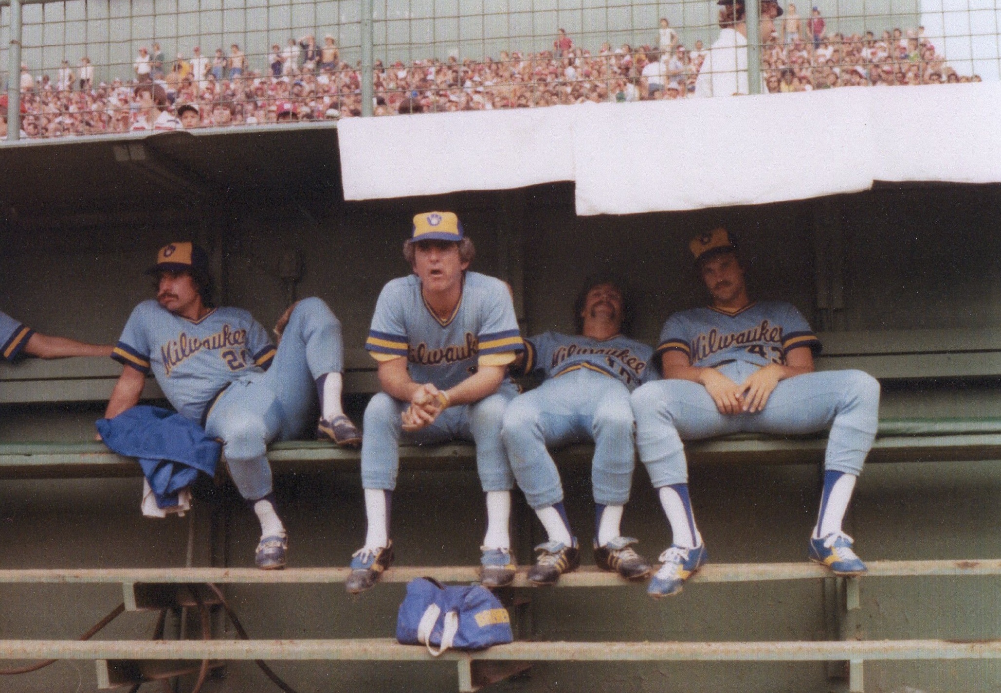 Milwaukee Brewers players sitting together in the dugout