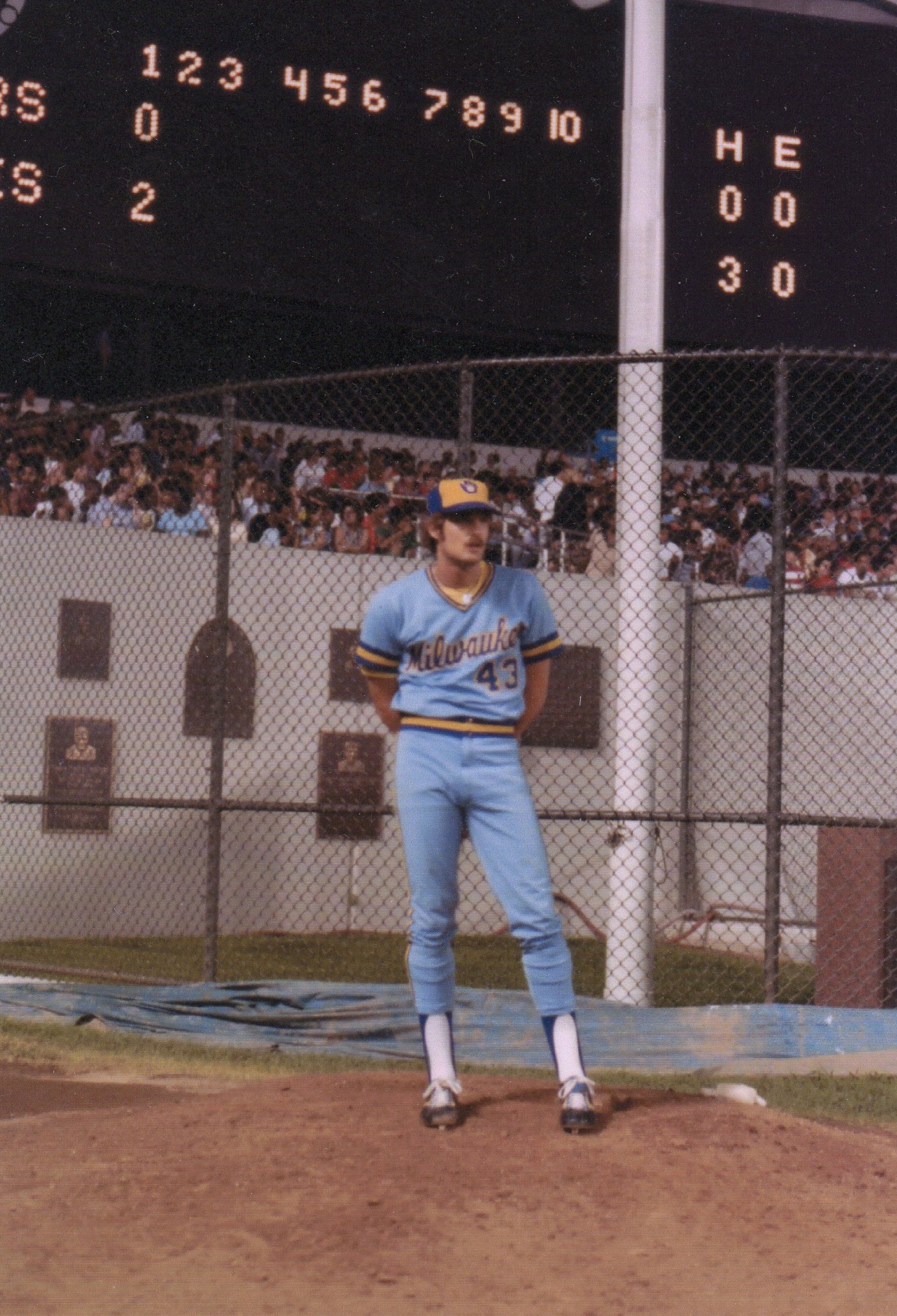 Randy in his Milwaukee number 43 uniform standing beneath a ballpark scoreboard